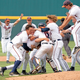 University of Virginia players crowd the mound in celebration.